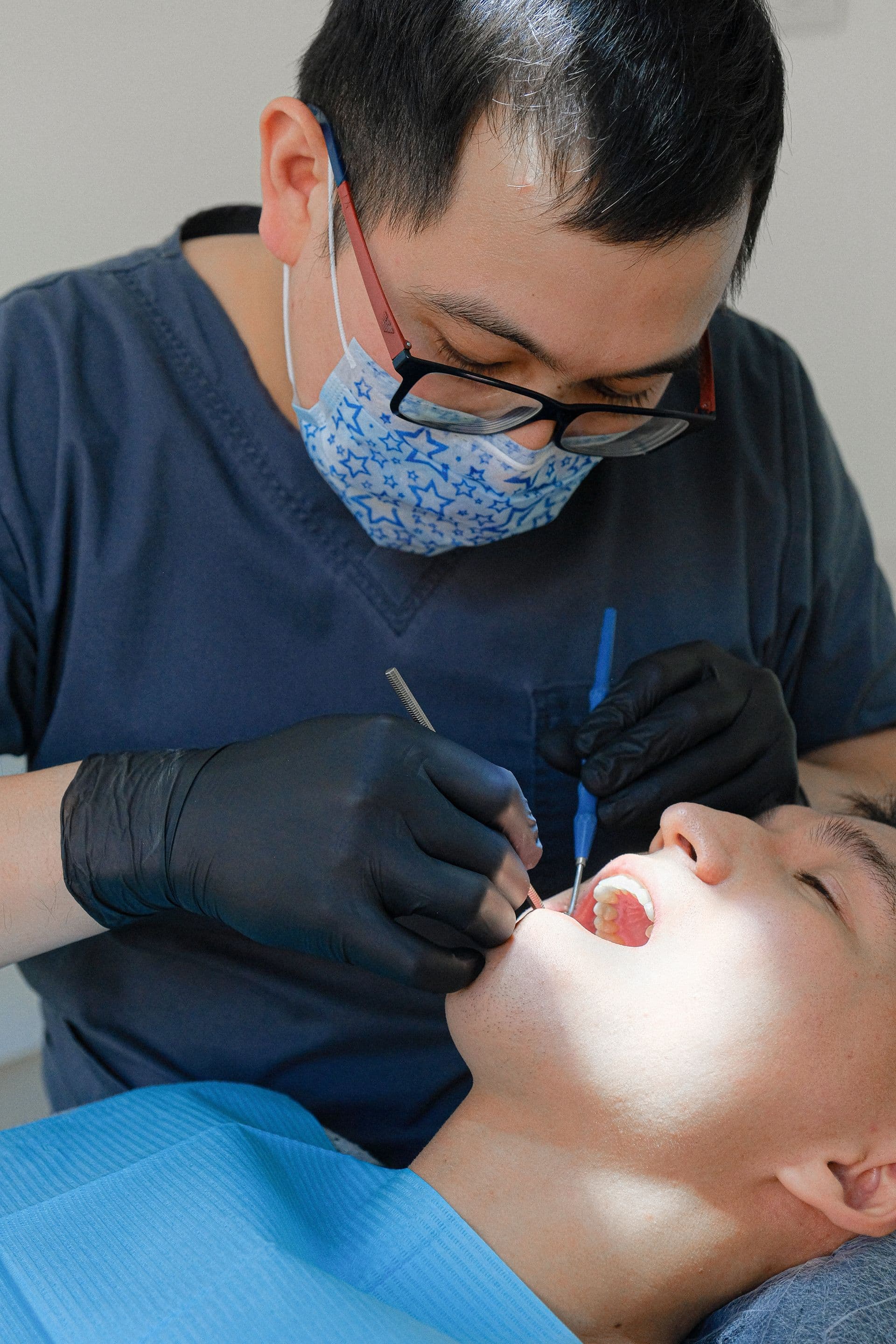 Dentist performing a dental exam with clinical tools